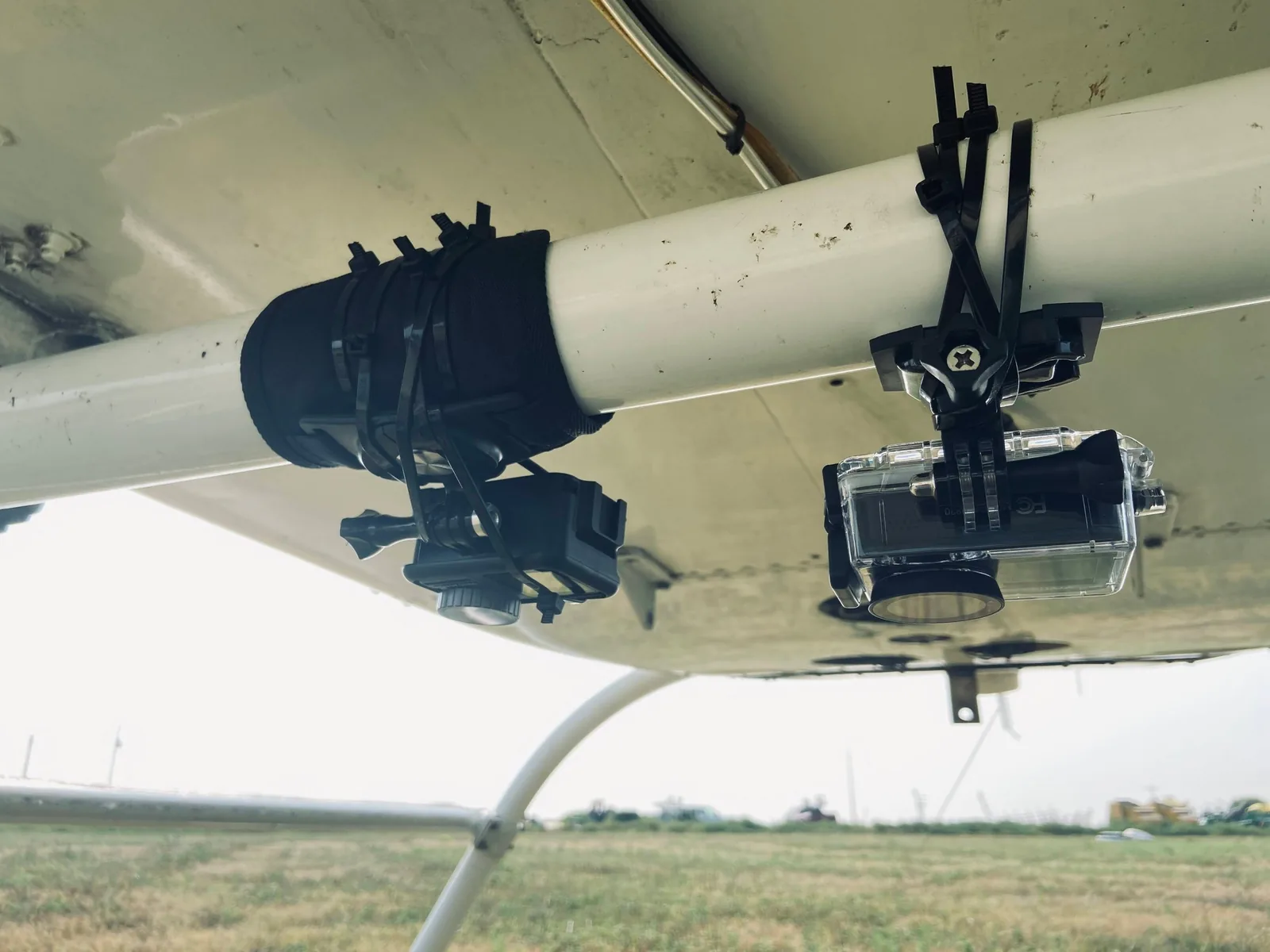 Two action cameras strapped under the helicopter's belly