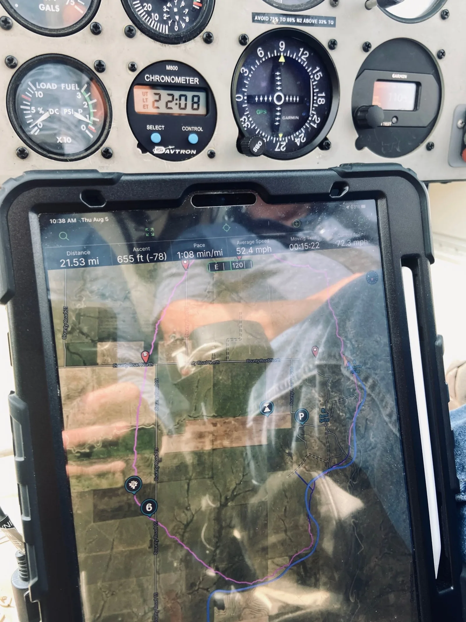 A tablet in the helicopter cockpit showing the loop of the route on a satellite map