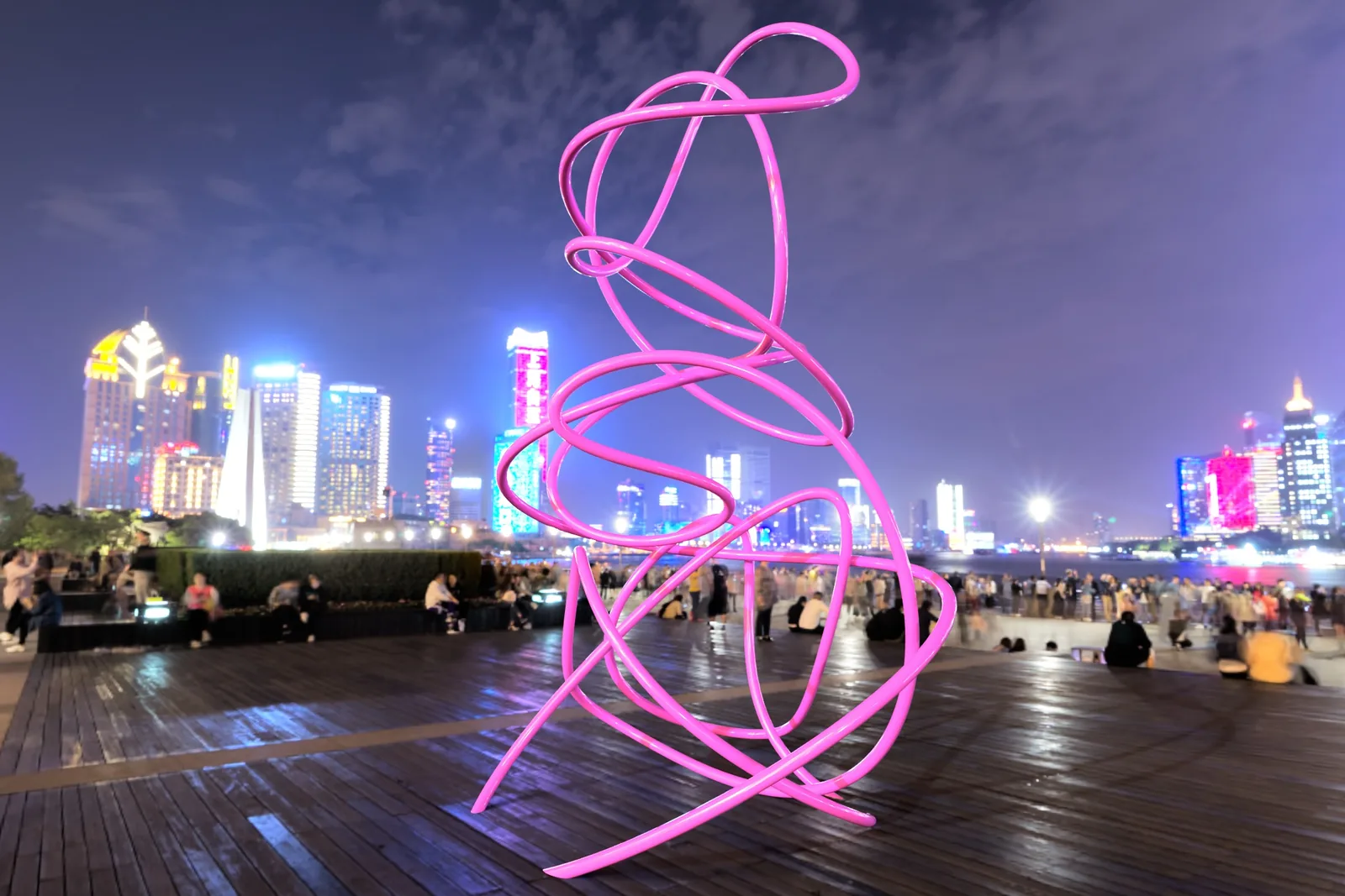 Rendering of a tall looping pink aluminum sculpture in an urban setting